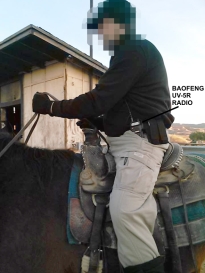 Militant at secret militia training camp in February 2016 on horseback with Baofeng UV-5R