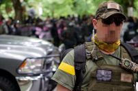 Right wing militant shows off his bubble pack radio outside Oregon statehouse in June 2019 with Midland GXT 1050VP4 Camo FRS GMRS UHF radio on Channel 7